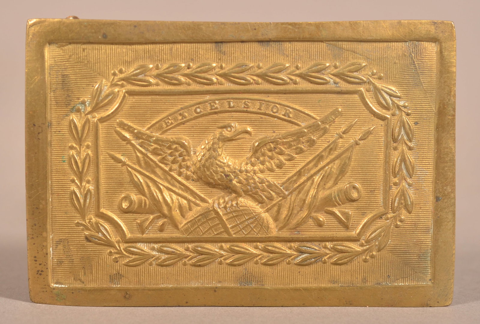 New York Militia Panel Plate: Rolled brass die-struck construction, applied brass tongue with belt loop bar with iron keepers, distinctive spreadwing eagle on globe, widely used as a New York military seal. Small pressure dents wi
