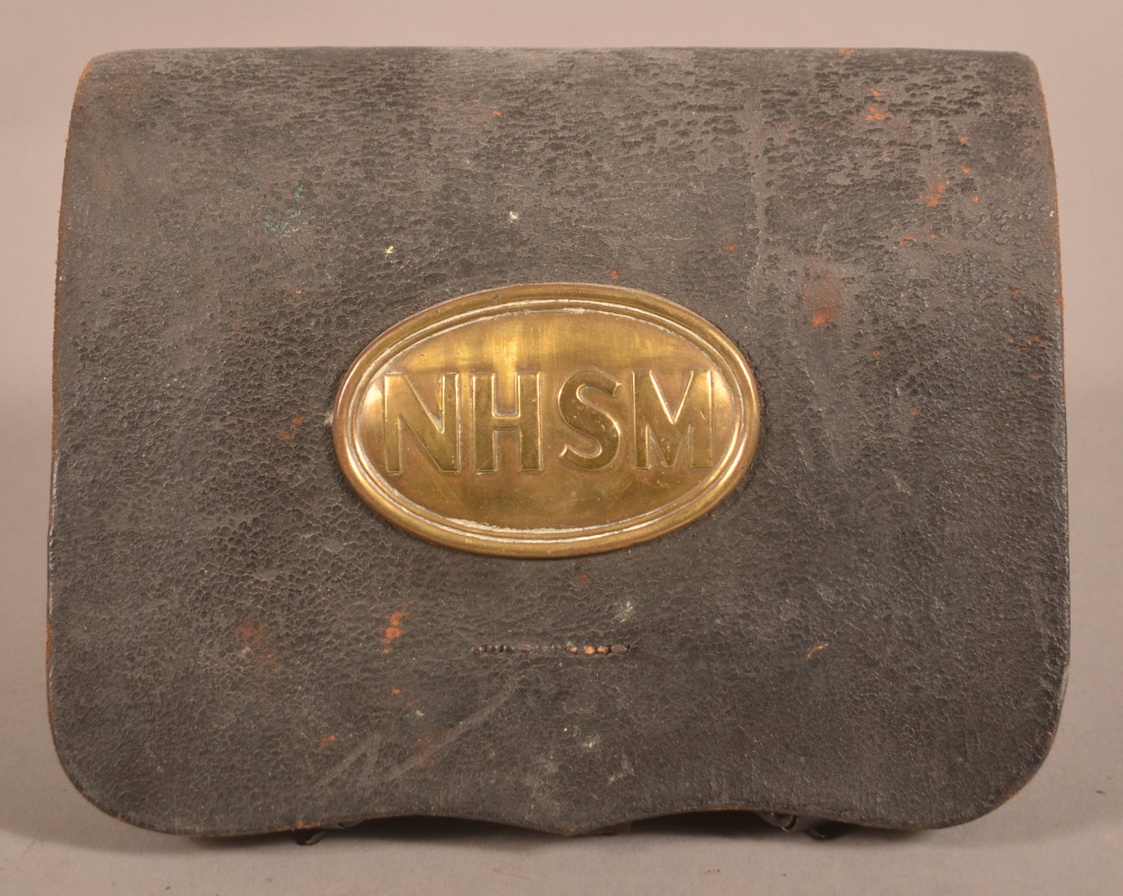 Watertown Arsenal 1863 Cartridge Box: Clear markings on the inner flap, intact belt loops and roller buckles. Includes a New Hampshire State Militia belt plate and tins. Age crazing with an aged, leather patina, supple aged leather with f