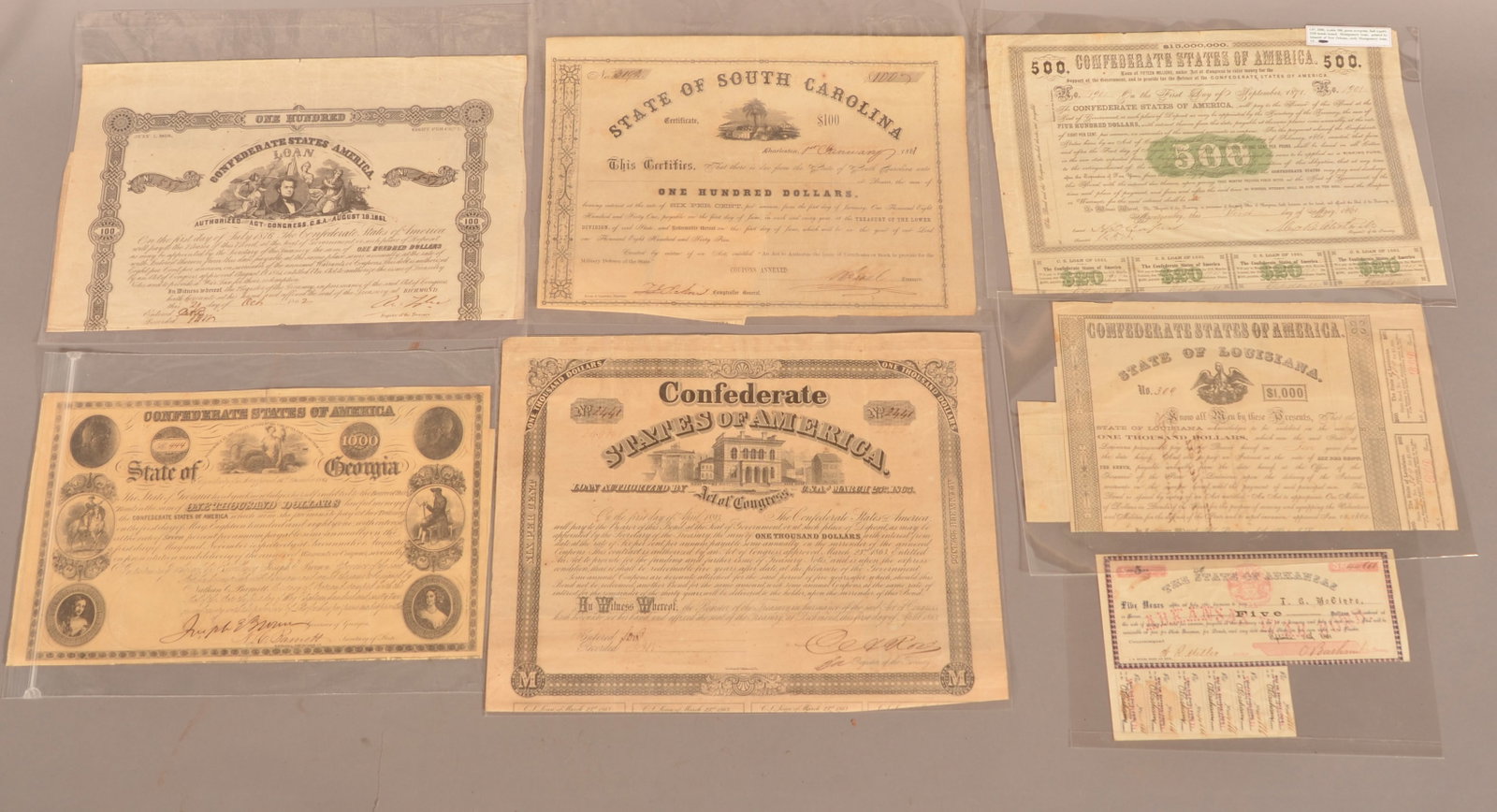 6 Confederate War Bonds: Arkansas, Louisiana, South Carolina, and Confederate States of America. Normal color toning and signs of age, some with missing coupons, overall fair condition.