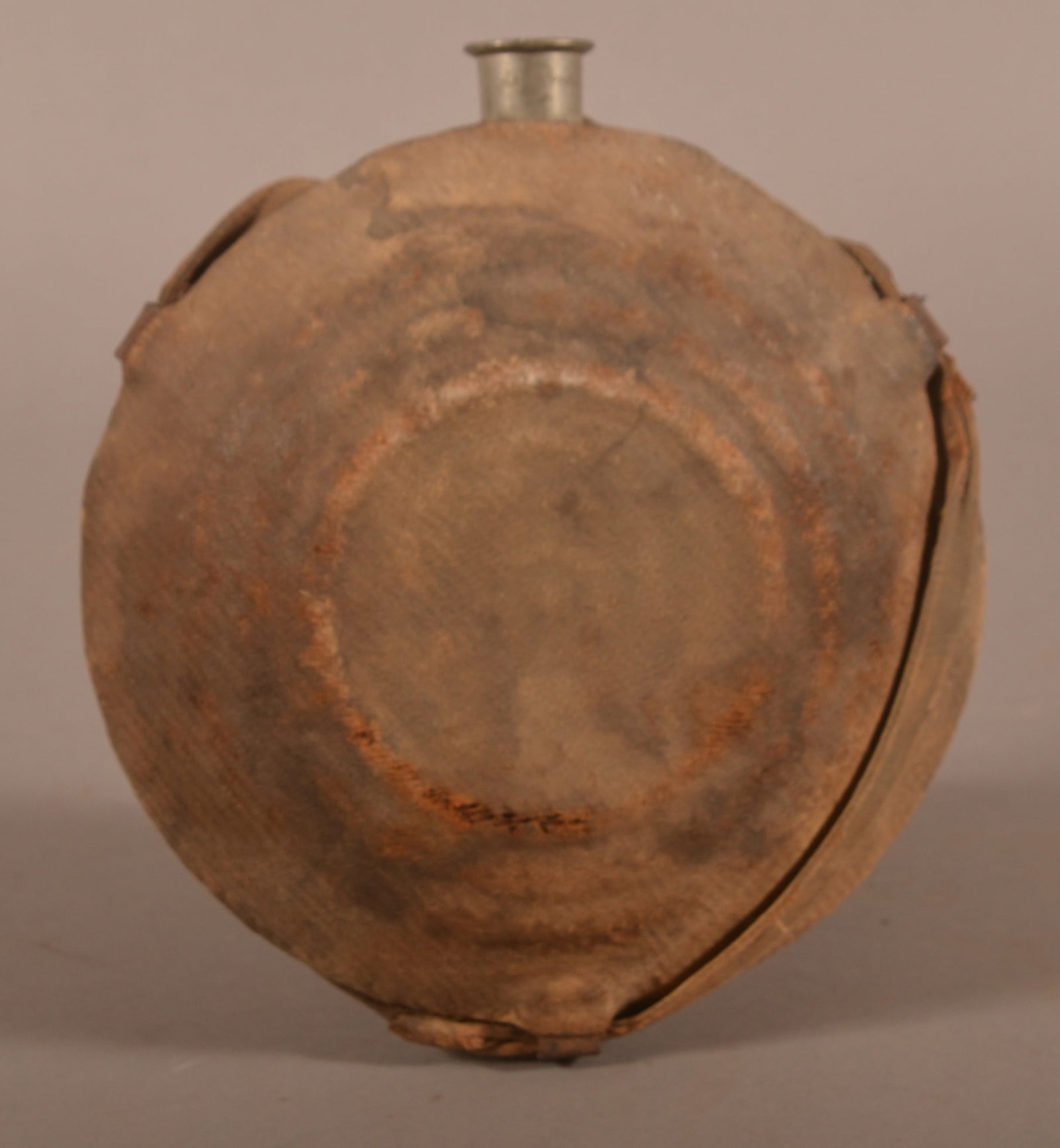 C.H. & Co. Phila. Model 1858 "Bullseye" Canteen: Clear maker's marks on the spout, missing stopper and chain, original wool covering that has excessive age discoloration and staining, large areas of fabric thinning and rub marks, iron fittings show 