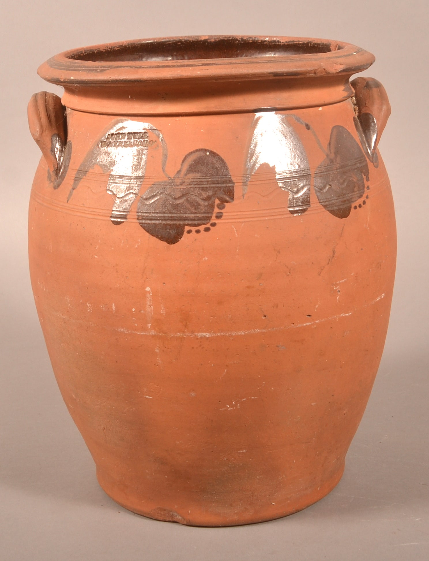 John Bell, Waynesboro, PA 3-Gal. Redware Crock.: John Bell, Waynesboro, PA 3-Gallon Redware Crock. Unglazed exterior with manganese tulip and foliate decorated shoulder. 13-1/2"h.