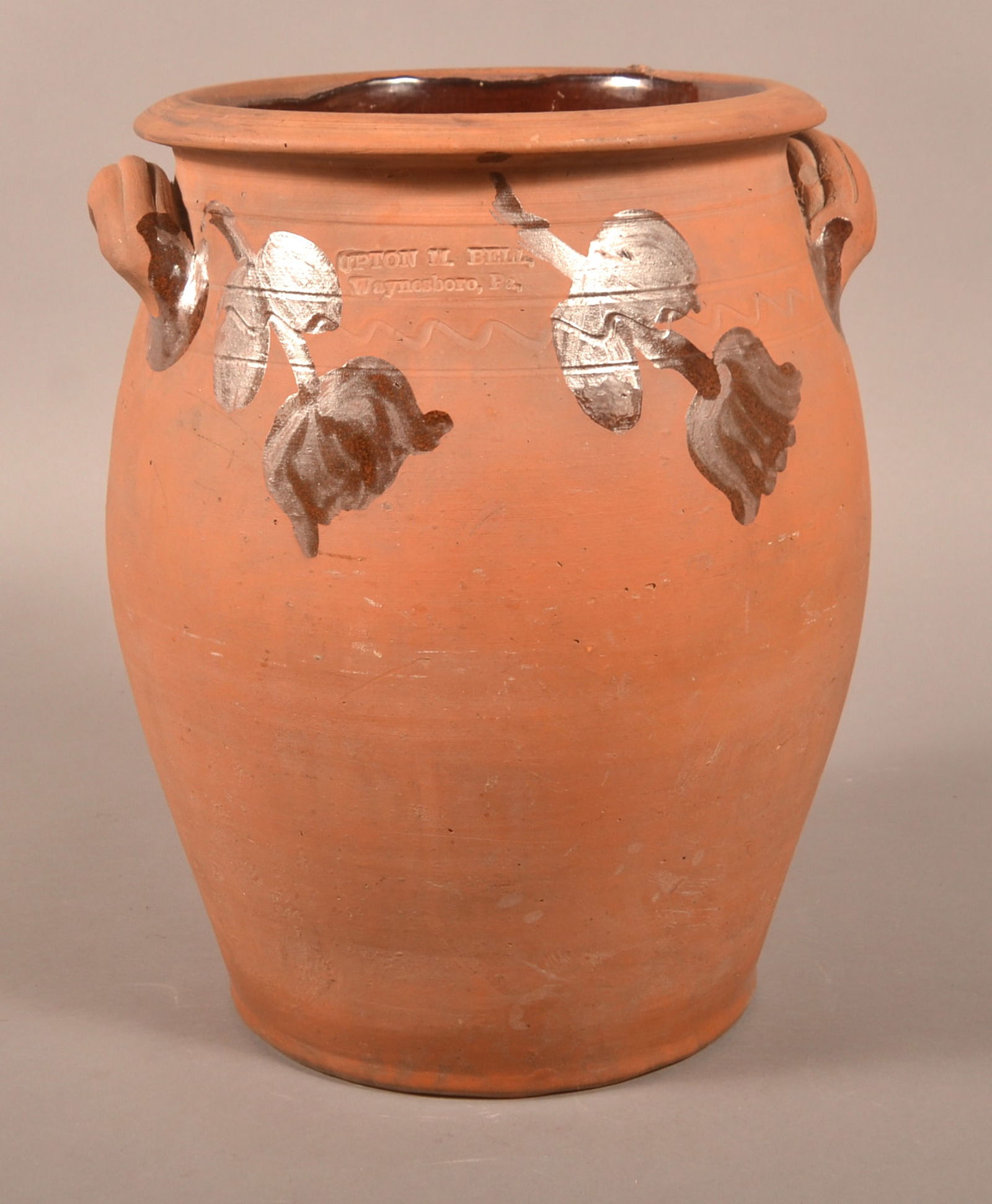 Upton M. Bell, Waynesboro, PA Redware Crock.: Upton M. Bell, Waynesboro, PA 3-Gallon Redware Crock. Double stamped. Unglazed exterior with manganese tulip and foliate decoration and incised band decorated shoulder. 14-1/2"h.