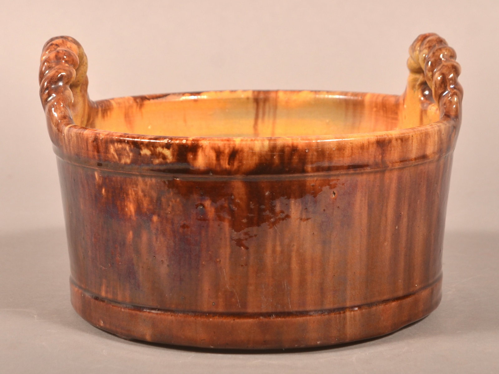 Upton Bell, Waynesboro, PA Redware Butter Tub.: Upton M. Bell, Waynesboro, PA Mottled Glaze Redware Butter Tub. Applied twisted rope handles and slightly tapered body with molded rim. 5-3/4"h. x 8-1/2" diam.
