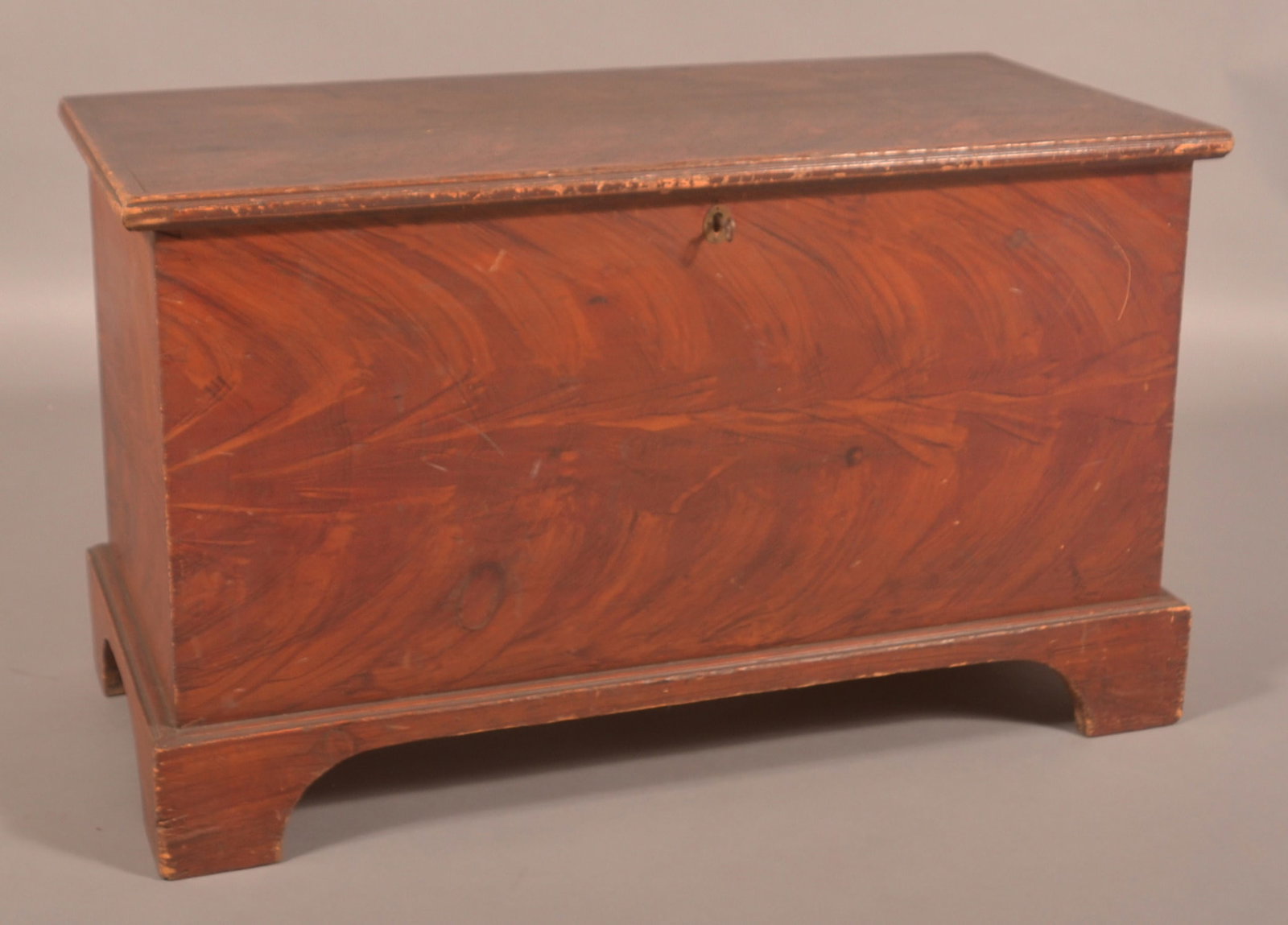 Pennsylvania Mid-19th C. Softwood Blanket Chest.: Pennsylvania Mid-19th Century Softwood Blanket Chest. Bold flame grain paint decoration, molded lid, dovetailed case, interior till, and molded, dovetailed bracket base. 22-1/2"h. x 38"w. x 18"d.