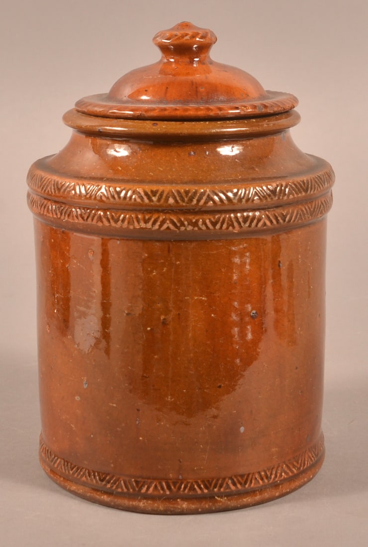 Pennsylvania 19th C. Redware Covered Canister.: Pennsylvania 19th Century Redware Covered Canister. Dome lid with gadrooned rim, base with flared rim, stamped-decorated raised bands on cylindrical body. 8-1/2"h.