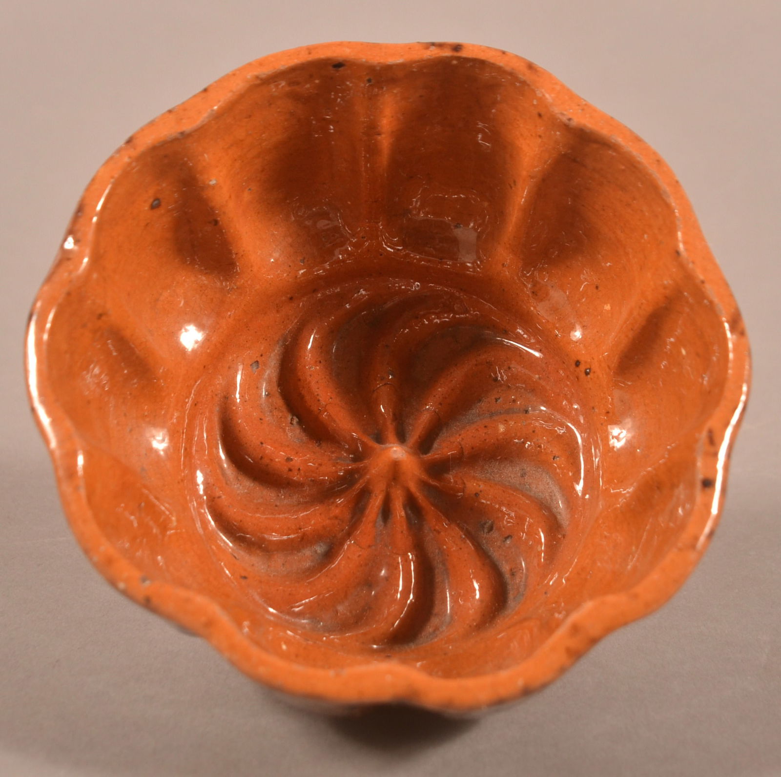 John Bell Mottled Glaze Redware Swirl Jelly Mold.: John Bell Mottled Glaze Redware Swirl Pattern Jelly Mold. With scalloped sides. 2-1/4"h. x 4-1/4" diam.