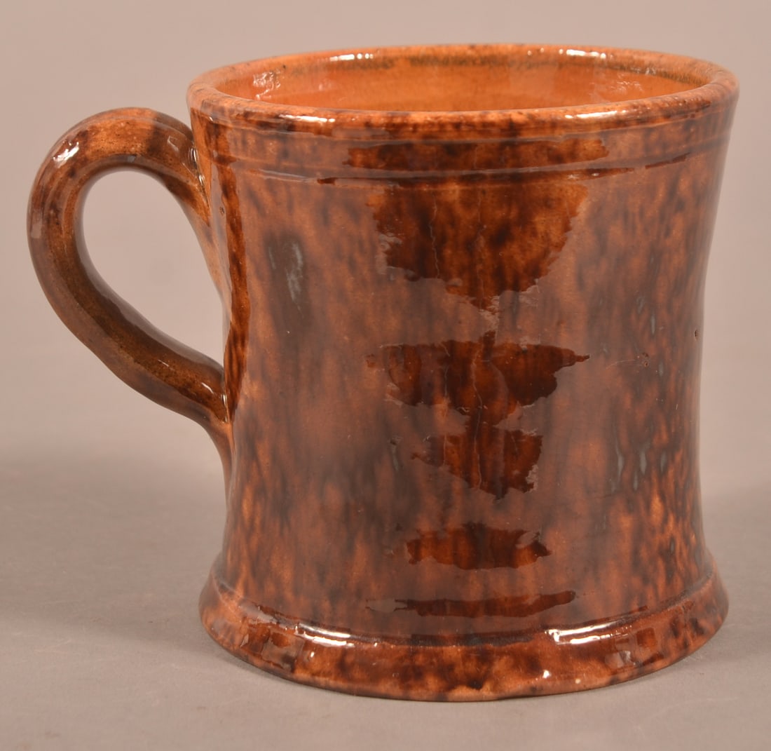 John Bell Mottled Glaze Redware Mug.: John Bell Mottled Glaze Redware Mug. Flared body with applied loop handle and molded base. 3-3/4"h.