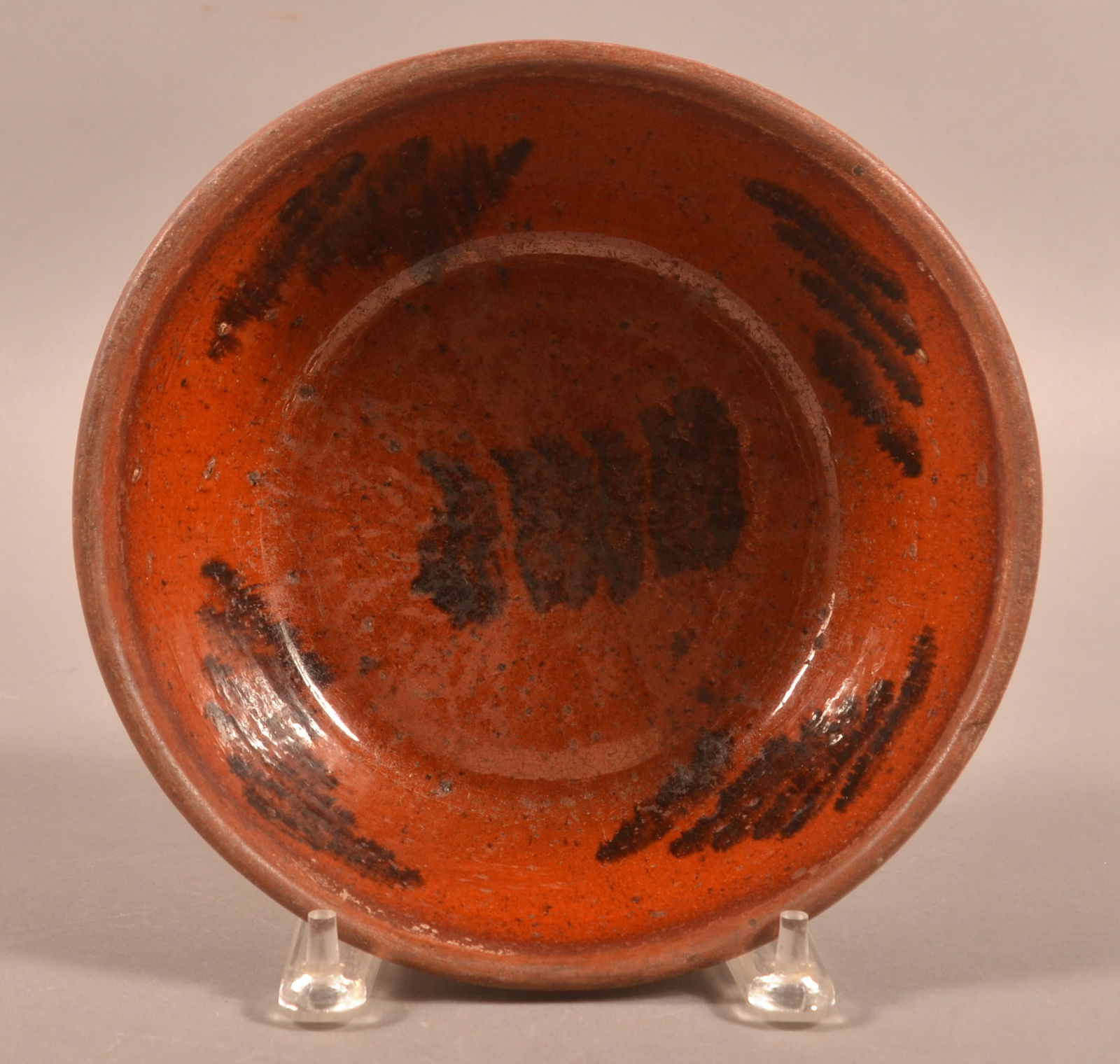 Pennsylvania 19th Century Redware Bowl.: Pennsylvania 19th Century Redware Bowl. With manganese sponge decoration on the interior glaze. 3-1/4"h. x 9" diam.