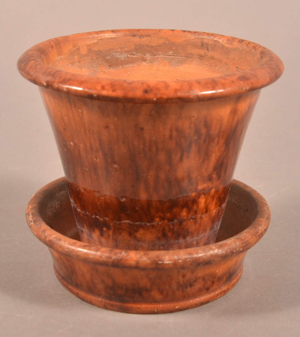 John Bell, Waynesboro, PA Sm. Redware Flowerpot.: John Bell, Waynesboro, PA Small Mottled Glaze Redware Flowerpot. Molded rim, tapered body, and attached saucer base. 4-3/8"h. x 4-3/4" diam.