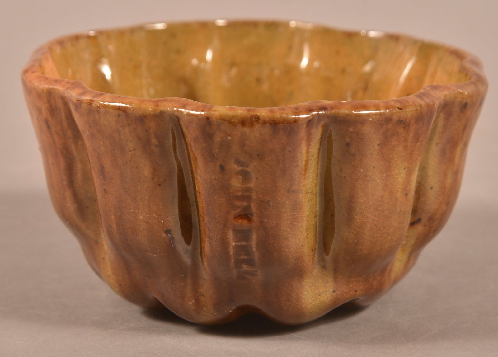 John Bell Mottled Glaze Redware Jelly Mold.: John Bell Mottled Glaze Redware Jelly Mold. Swirl pattern with scalloped sides. 2-1/4"h. x 4-1/4" diam.