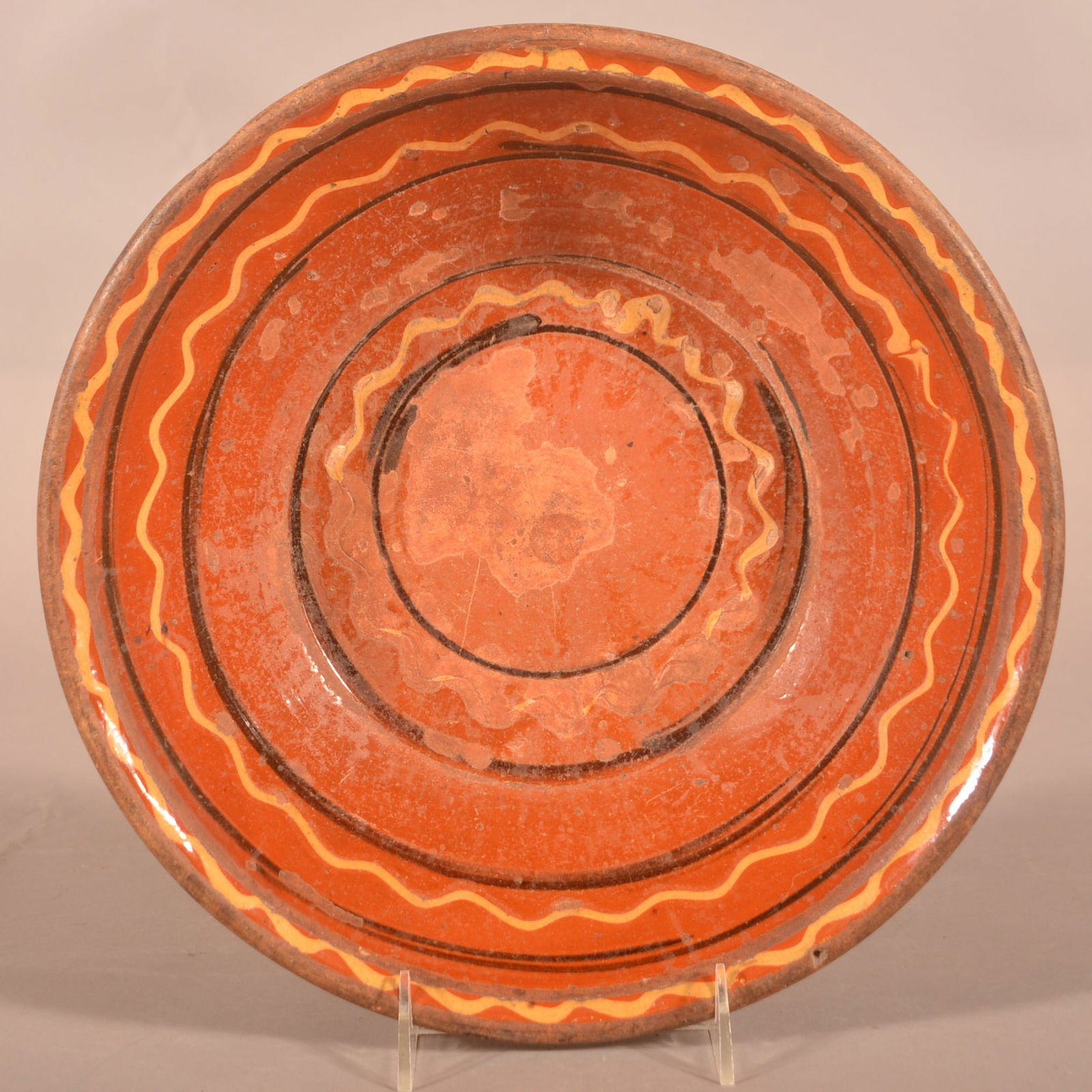 PA 19th Century Redware Slip-Decorated Milk Bowl.: Pennsylvania 19th Century Redware Manganese and Yellow Slip-Decorated Milk Bowl. Molded rim and tapered sides. 3"h. x 12" diam.