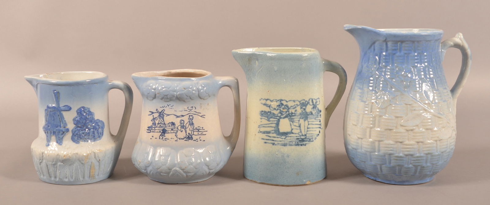 Four Blue and White Glazed Stoneware Pitchers.: Four Blue and White Glazed Stoneware Pitchers. Tallest, 10-1/4"h.
