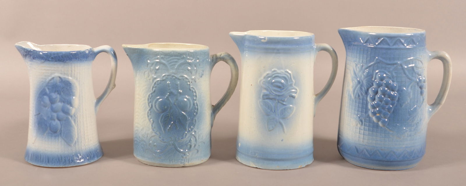 Four Blue and White Glazed Stoneware Pitchers.: Four Blue and White Glazed Stoneware Pitchers. Tallest, 9-1/2"h.
