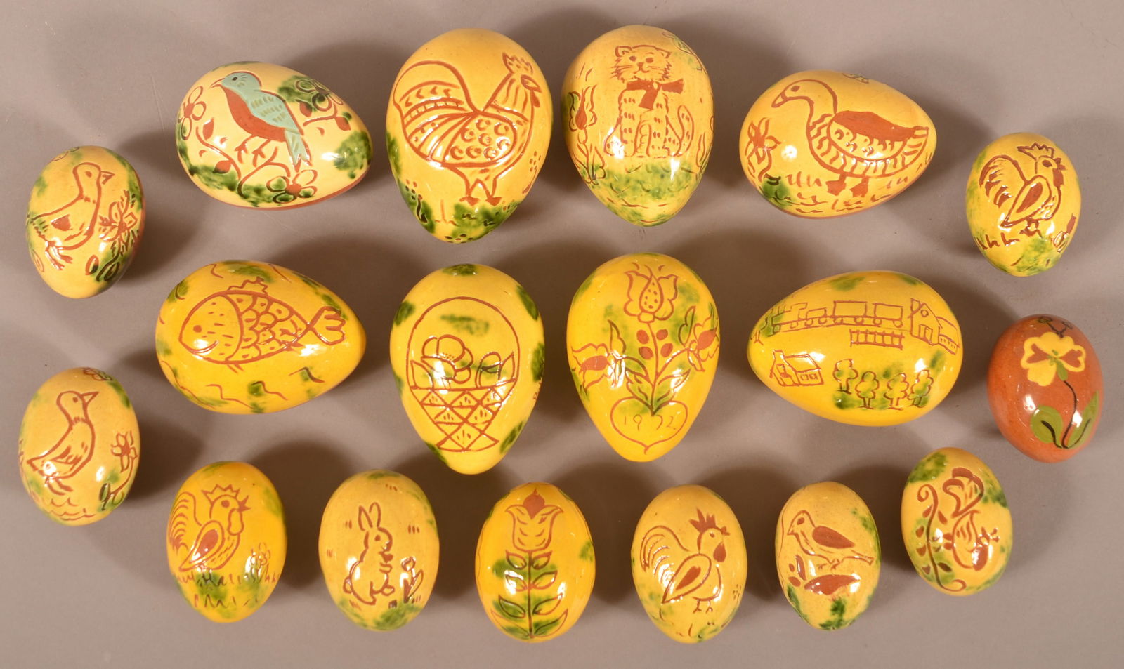 Collection of Breininger Redware Easter Eggs.: Collection of Breininger Redware Easter Eggs. 18 eggs total measuring from 2" to 3-1/2"l.