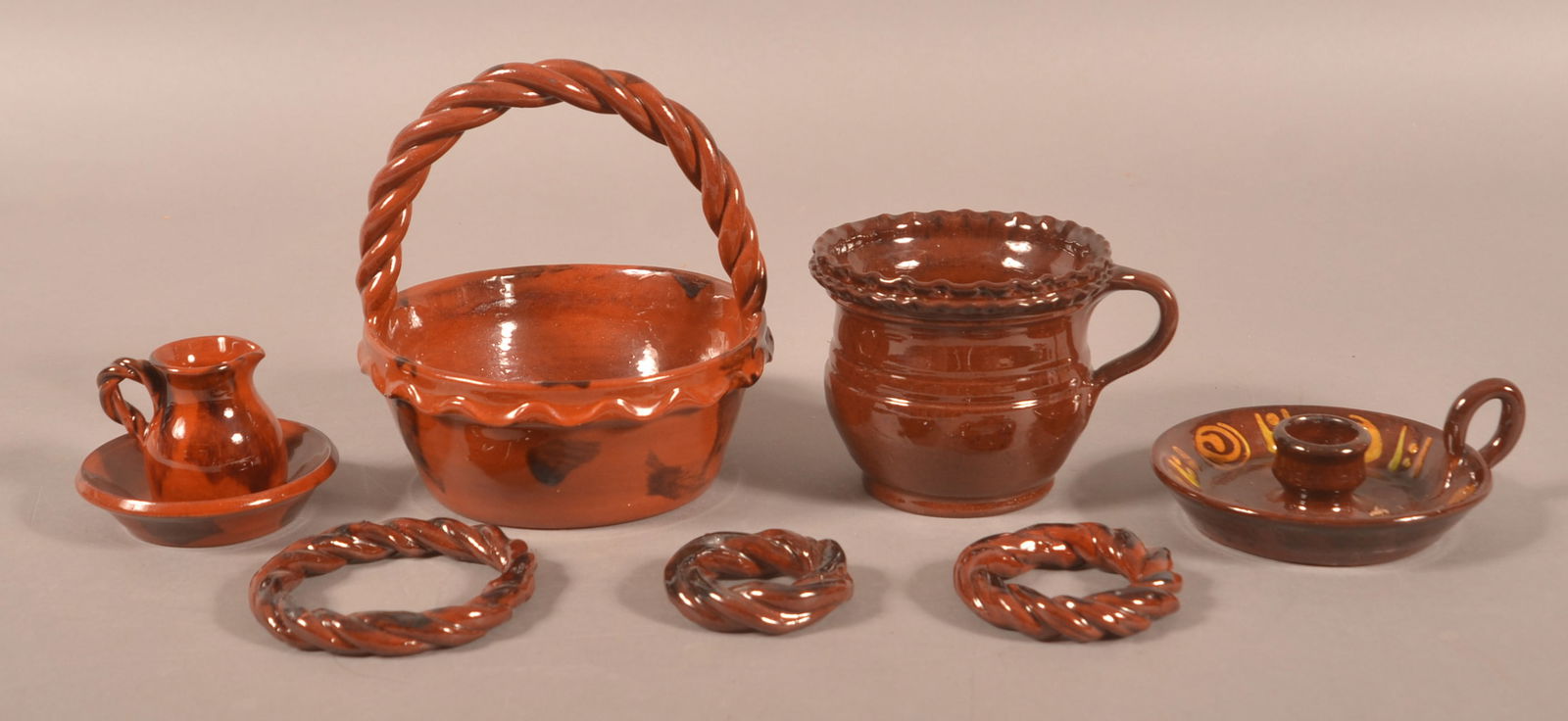 Group of Contemp. Redware by Foltz & Breininger.: Group of Contemporary Redware by Foltz and Breininger. Stacking wreaths, candle holder and small pitcher by Foltz. Rope twist-handled basket and small pitcher, and saucer by Breininger. Tallest, 6"h.