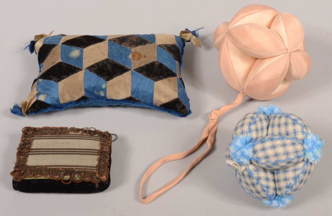 Four Filled Fabric Sewing Pieces. Two Amish type sewing: Four Filled Fabric Sewing Pieces. Two Amish type sewing balls. A two tone pink satin ball, 4" and a blue tabby woven ball with blue tassels, 3 1/2"dia.; an optic 3-D cube sewn pin pillow in black velv