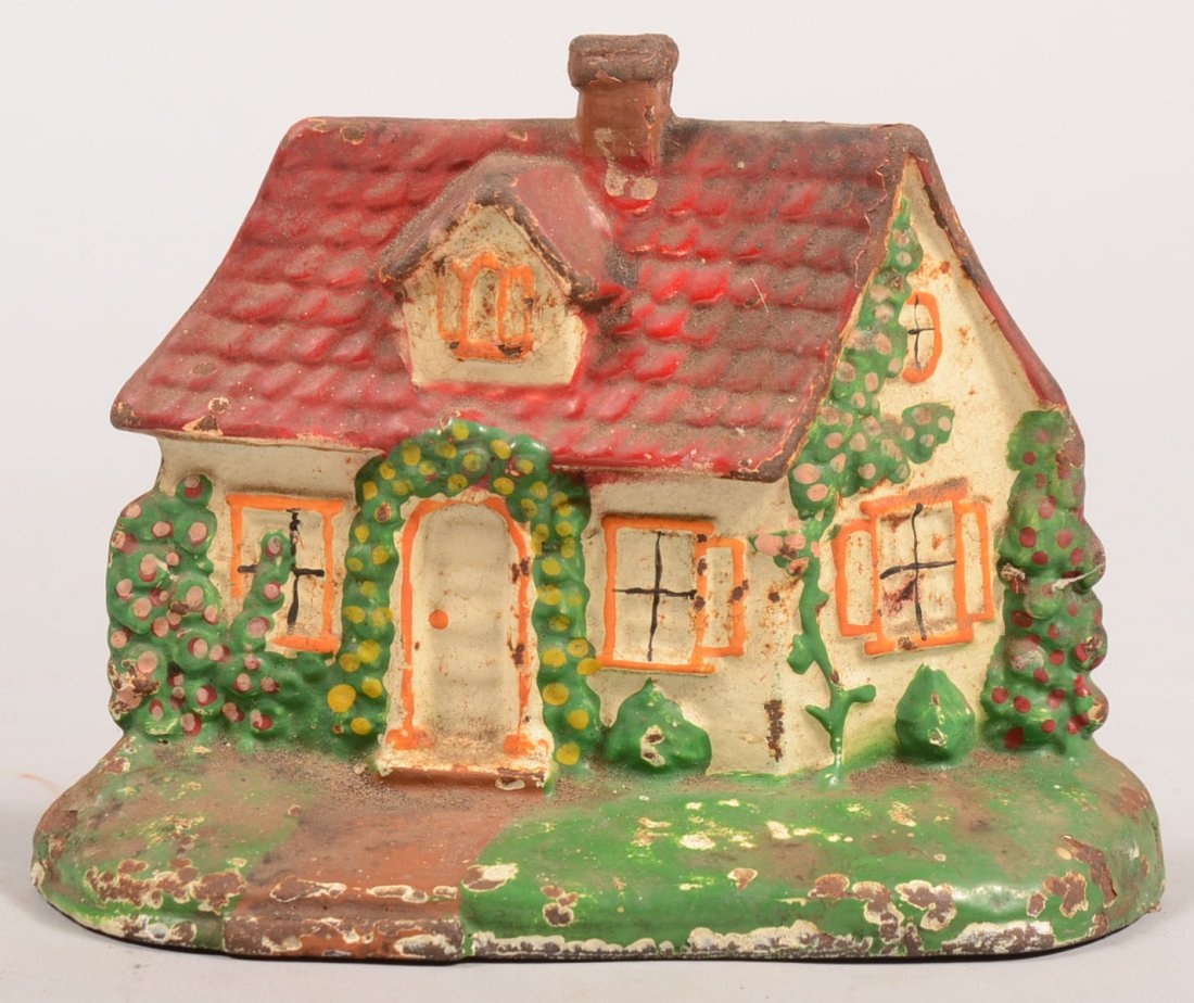 Painted Cottage Type Cast Iron Door Stop. Red tile roof: Painted Cottage Type Cast Iron Door Stop. Red tile roof on a flowering green arbor clad white building. Possibly Hubley. 5 5/8"h. X 7 1/4"w.