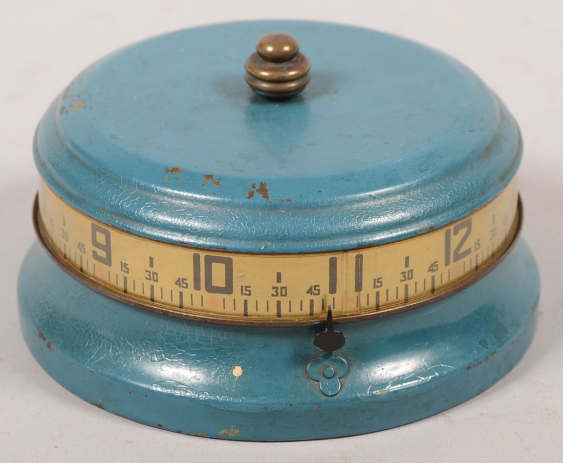 Blue Painted Brass Table Top Drum Clock. Unmarked. Top : Blue Painted Brass Table Top Drum Clock. Unmarked. Top cover has banded chapter ring on side and is geared to rotate with fixed indicator arrow on side defining the time. Brass works within circular b