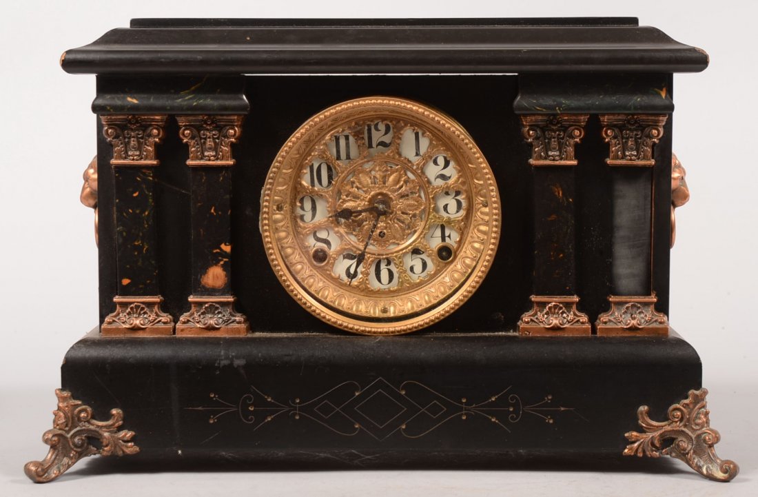 Black Painted Wood Mantle Clock with Copper Ormolu. Cas: Black Painted Wood Mantle Clock with Copper Ormolu. Case decorated with cast copper lion's heads with drop rings on sides, fancy front feet simple and bracket feet on rear, four faux marble columns wi