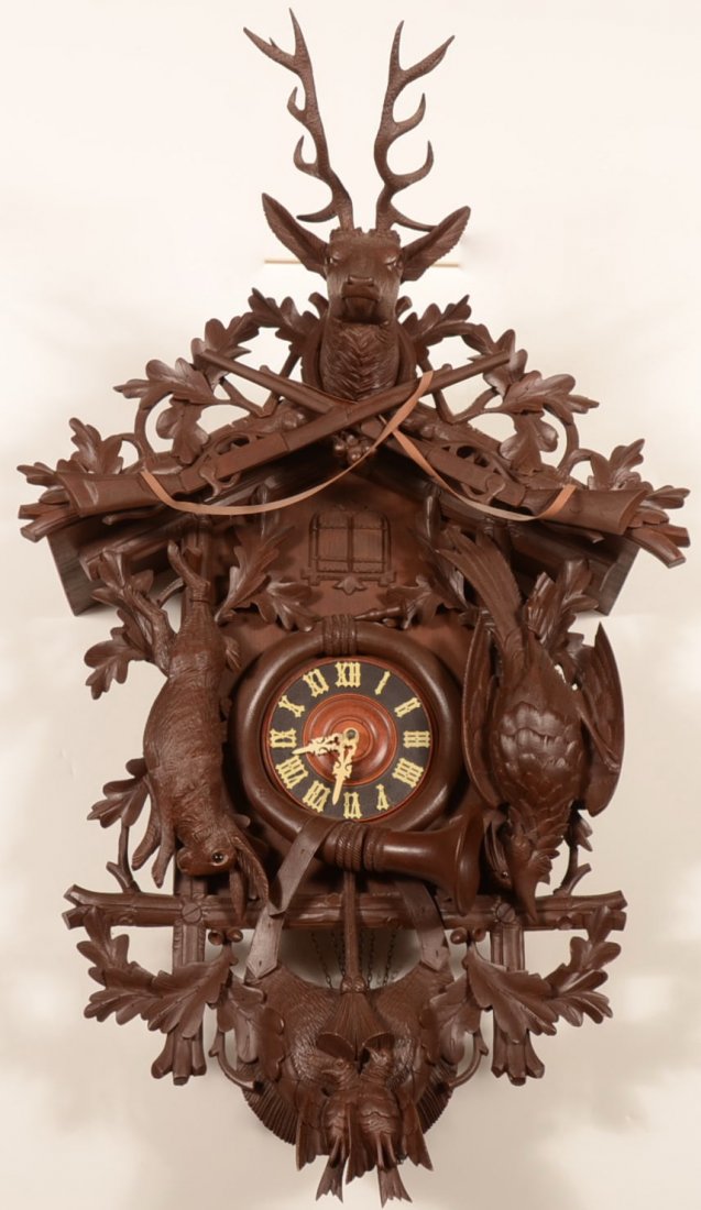 20th Cent. Carved Black Forest Cuckoo Wall Clock.: 20th Cent. Carved Black Forest Cuckoo Wall Clock. Eight day, weight driven wall clock has a carved face surround including hare, pheasant, two doves, hunting horn and bag with oak leaves, Roman numera