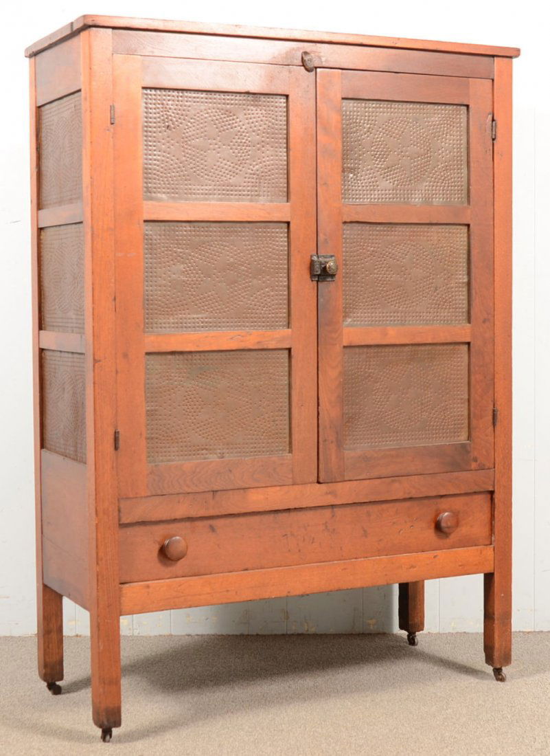 Walnut Pine Safe with Star Punched Tin Panels. Flat top: Walnut Pine Safe with Star Punched Tin Panels. Flat top over two doors with three stacked tin panels over a full width drawer with wood pulls. Full length stiles become legs. Sides each have three sta