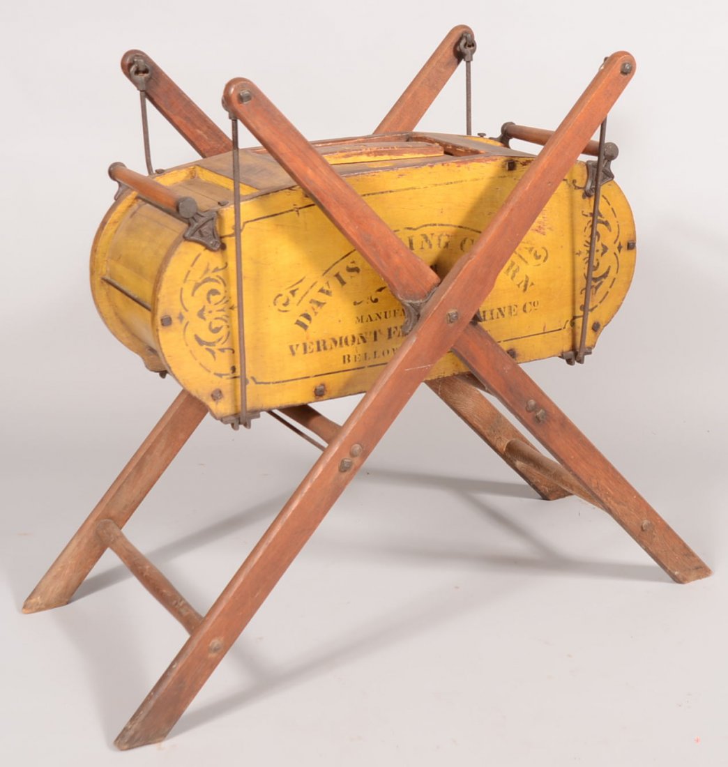 Yellow Davis Swing Churn. A frame hung swinging butter : Yellow Davis Swing Churn. A frame hung swinging butter churn made by Vermont Farm Machine Co., Bellows Falls ,Vt. Labeled as a No. 3 in black stenciling with additional decorative stenciling. Iron han