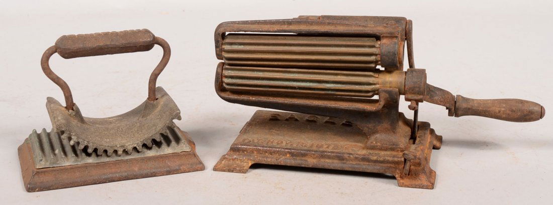 Two Different Cast Iron Fluting Irons. A platform type : Two Different Cast Iron Fluting Irons. A platform type with surface clamp, crank handle and brass rollers marked: "Eagle" and dated 1876. 57 1/2"w. 1/2"h. X 9"w. Along with a free hand crescent type a