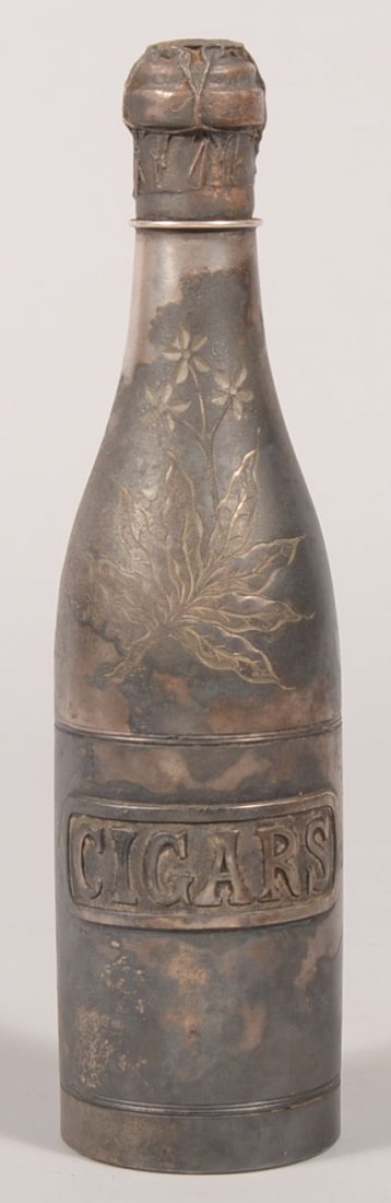 Silver Plated Pairpoint Cast Metal Cigar Safe. Made in : Silver Plated Pairpoint Cast Metal Cigar Safe. Made in the form of a champagne bottle with applied label bearing: "CIGARS." Incised flowers and tobacco leaf designs on face of upper half. Bottle unscr