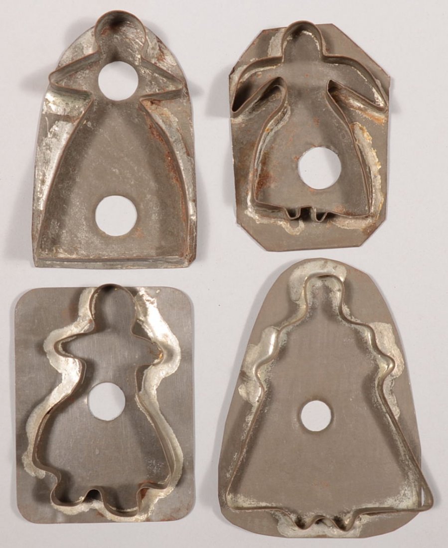 Four Female Figural Tin Cookie Cutters. All cutters wit: Four Female Figural Tin Cookie Cutters. All cutters with full skirted women figures. 4 1/2"h., 4 3/8"h., 4"h. and 3 7/8"h. Condition: All good with use wear.