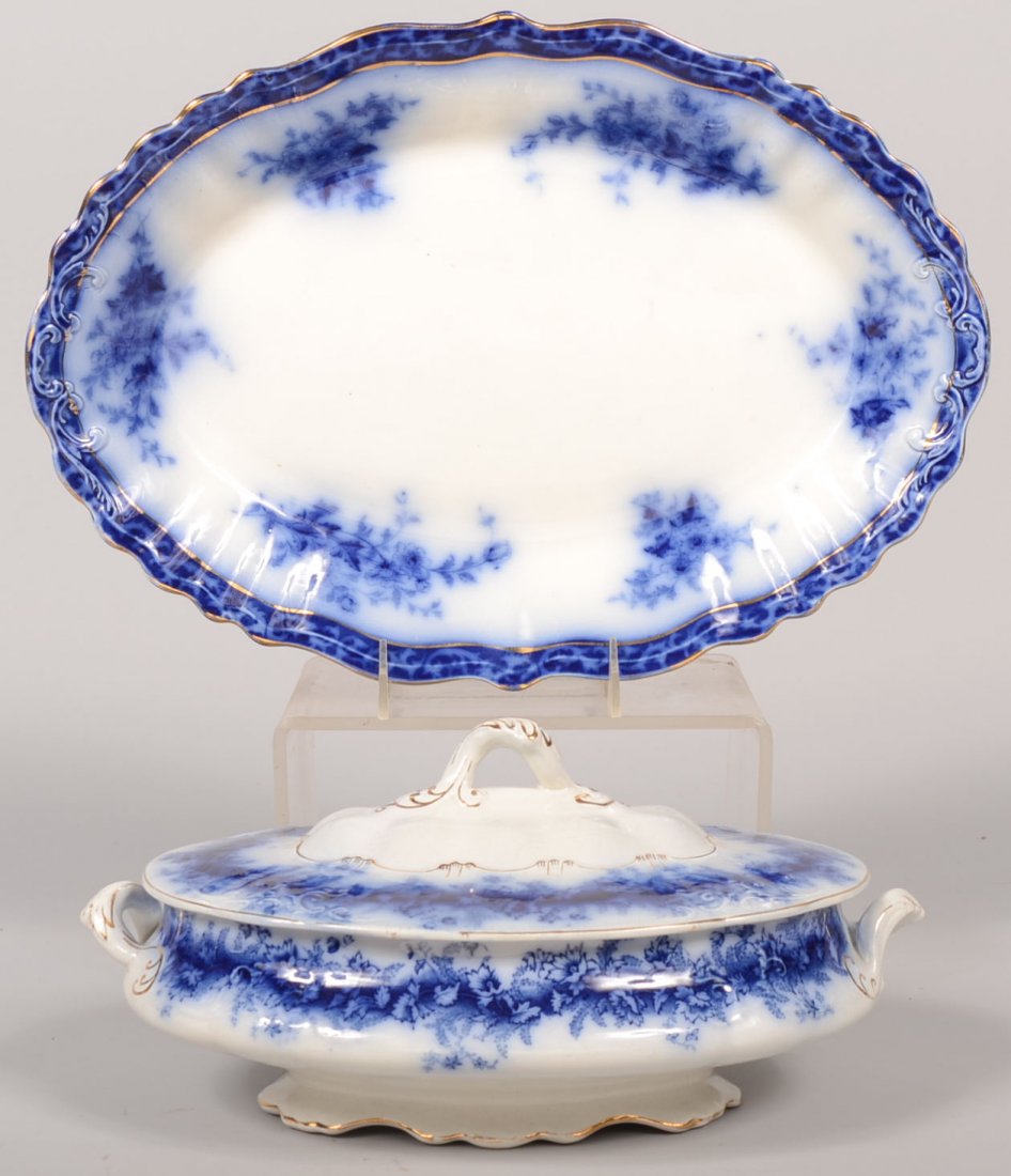 Two Pieces Flow Blue Dinnerware. An oval covered vegeta: Two Pieces Flow Blue Dinnerware. An oval covered vegetable in the "Garland" pattern by W. & E. Gorn, England. Raised scalloped foot, opposing loop handles, scalloped rim cover with looped top handle.