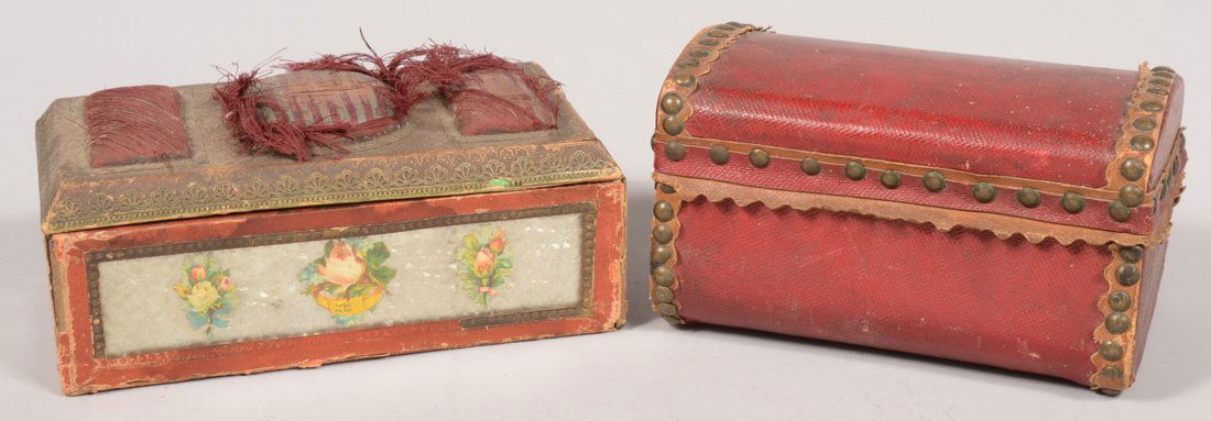 Two Small Trinket Boxes. A loaf shaped trunk like box c: Two Small Trinket Boxes. A loaf shaped trunk like box covered in a textured red leather with brass tack edge binding, hinged lid conceals a royal blue paper lining. 4"h. X 7"w. Together with a colored