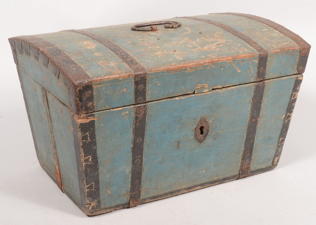 Blue Painted Metal Banded Small Wood Trunk. Trapezoidal: Blue Painted Metal Banded Small Wood Trunk. Trapezoidal end profile with black metal edge binding and wrought iron bail on hinged lid. Oval iron key hole escutcheon. Chest has lock and is locked. No k