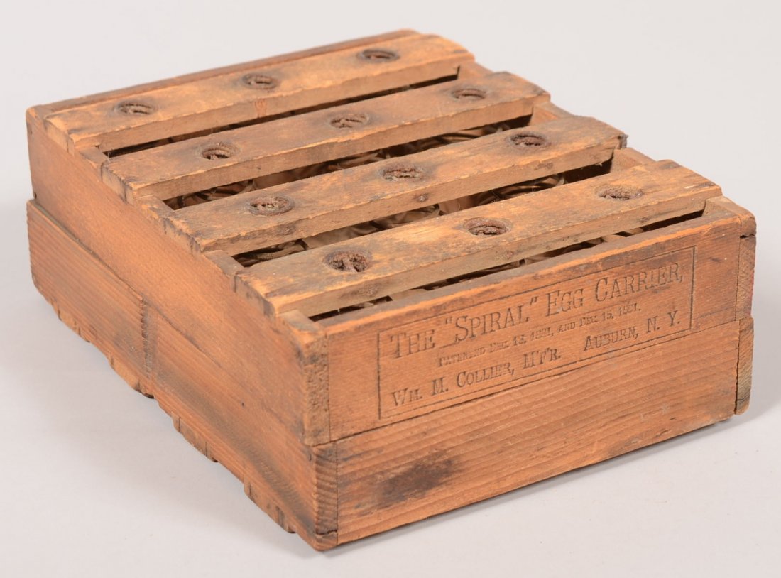 The "Spiral" Egg Carrier. Small slatted wooden crate li: The "Spiral" Egg Carrier. Small slatted wooden crate lined with twelve pair of coiled wire springs each pair holds an egg. Hinged in to halves. Imprinted label on one end includes patent date: Dec. 18