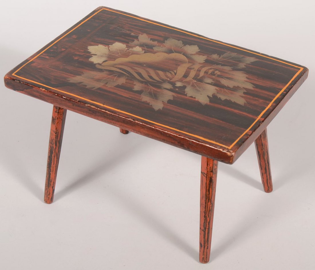 Bronze Powder Stenciled and Grained Foot Stool. Rosewoo: Bronze Powder Stenciled and Grained Foot Stool. Rosewood paint graining in dark brown and red with a gold and silver powder stencil of a conch shell with leaves on top surface. Four tapered and splaye