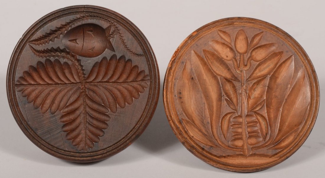 Two Carved Round Wood Butter Prints. One design incorpo: Two Carved Round Wood Butter Prints. One design incorporates a tulip and pomegranate with long leaves and incised border line. 4 1/4"dia. The other design is of three leaves with a strawberry and havi