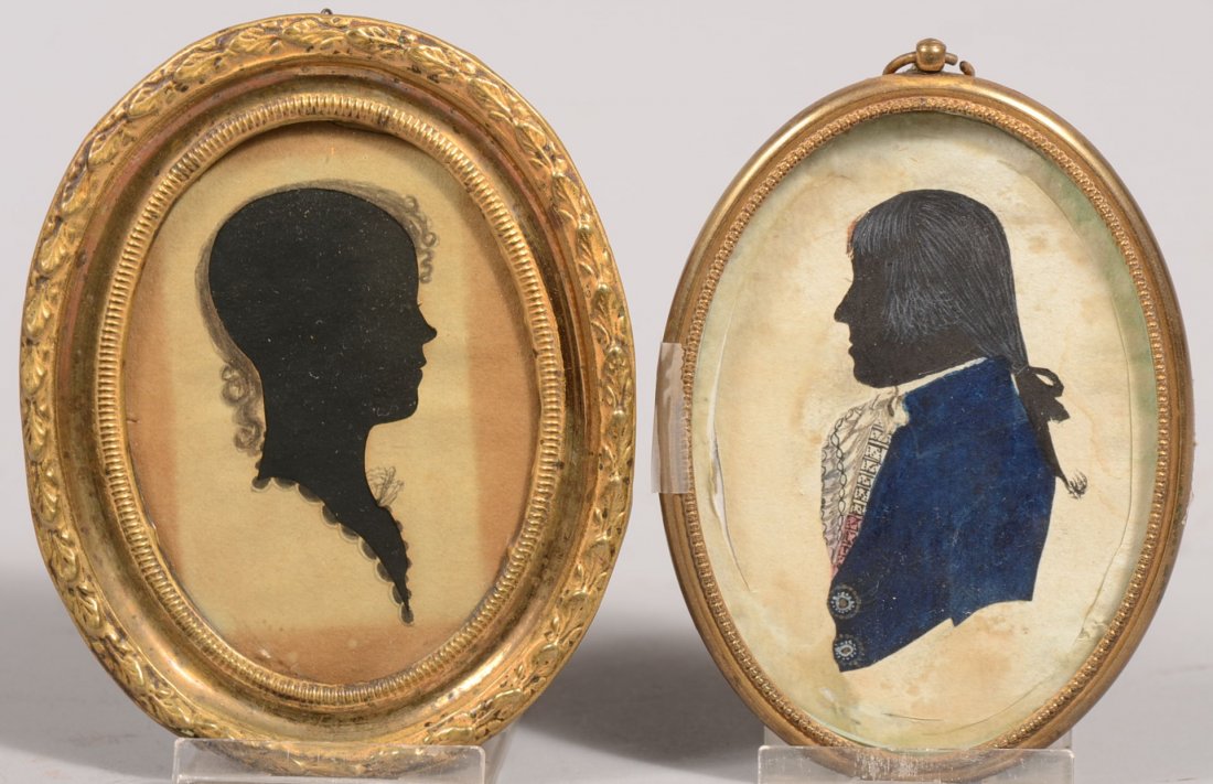 Two Oval Framed Silhouettes. A right facing young woman: Two Oval Framed Silhouettes. A right facing young woman with penned in hair and neckline costuming. Mounted in a stamped brass faced wood frame. 3 7/8"h. X 3"w. Along with a left facing man with penne