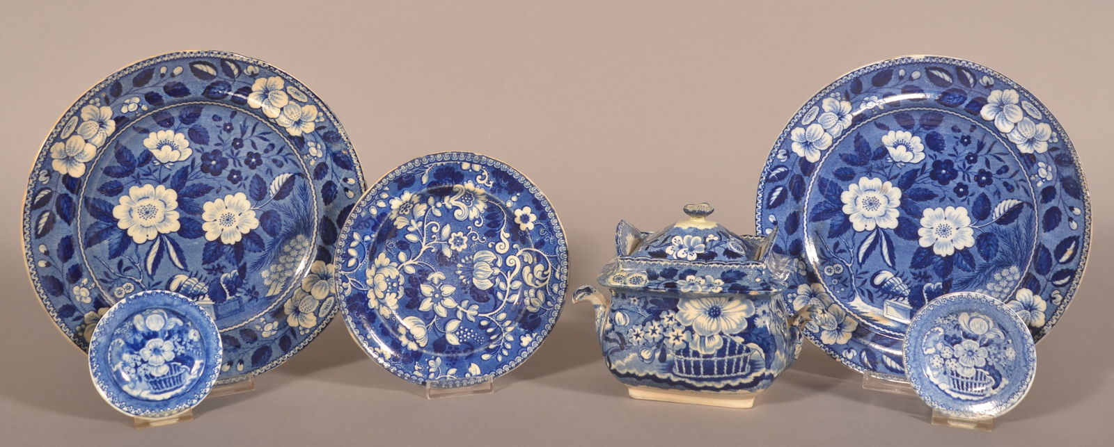Six Pieces of Staffordshire Blue Transfer China.: All with floral transfer designs. Including a covered sugar bowl stamped "Adams", two dinner plates, dessert plate and two cup plates. Largest plate, 9-3/4" diam.