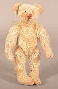 Antique Ivory Mohair Hump-Back Teddy Bear.: Unsigned, attributed to Hecla, American, early 20th century. 5-way jointed with brown stitched nose and claws, glass eyes. Squeaker not working. 11" H x 6" W x 4" D