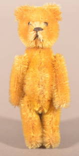 Schuco Perfume Bottle Mohair Teddy Bear.: Germany, circa 1920's. 5-way jointed golden mohair, with black metal bead eyes, black horizontally stitched nose, removable head revealing glass perfume vial. 3-1/2" H x 1-1/2" W x 1" D