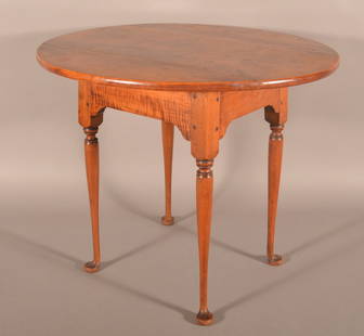 Queen Anne Cherry and Tiger Maple Tavern Table.: American with oval top, shaped skirt, turned legs with pad feet. Pegged construction. 25-1/2"H x 31-1/2" W x 28-1/2" D