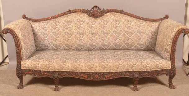 Antique American Ornately Carved Upholstered Sofa.: Mahogany frame with tapestry upholstery. Serpentine-back with central shell, foliate and reeded carving, scrolled arms having gargoyle rosettes, foliate and shell carved sides, skirt having elaborate
