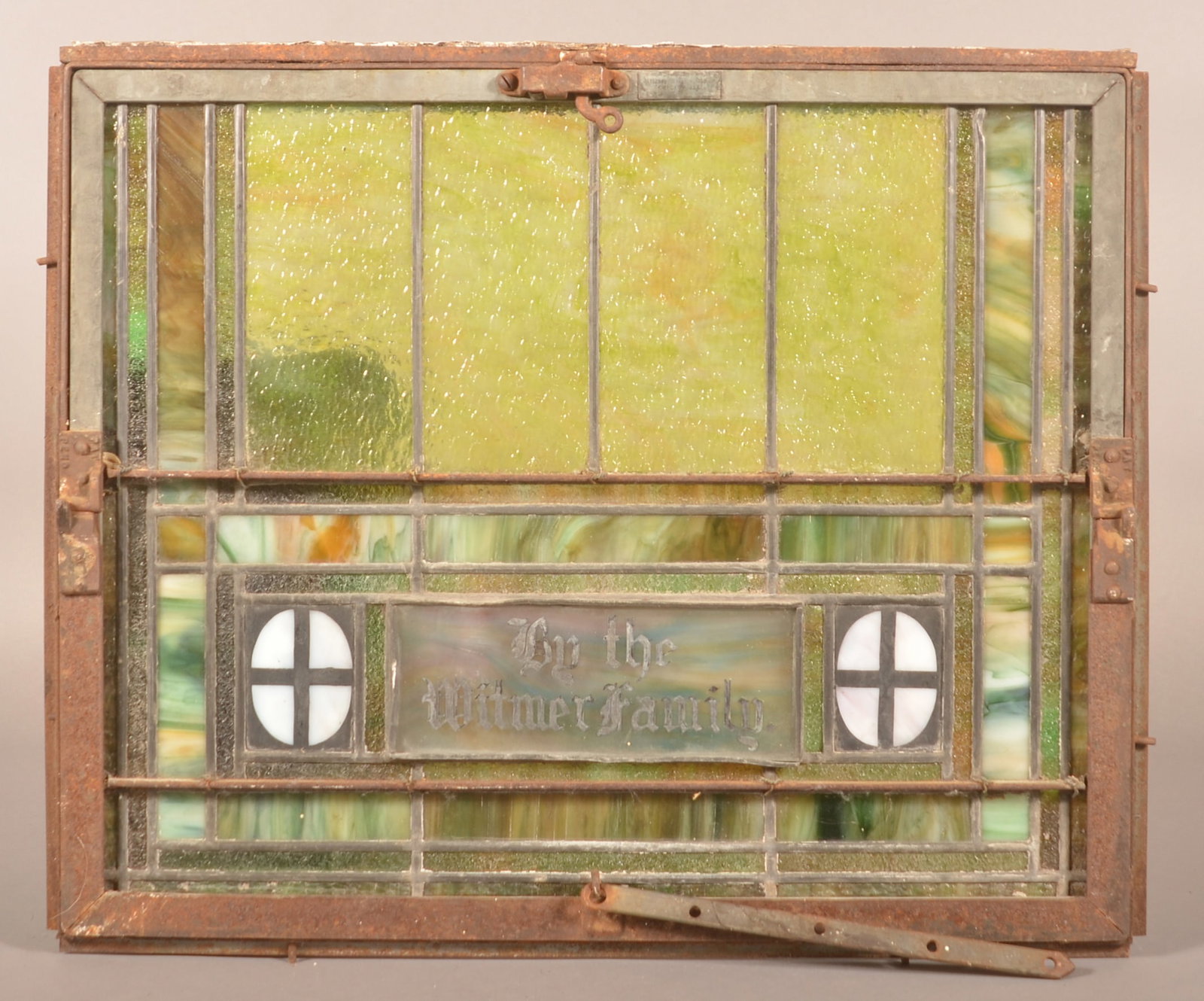Antique Leaded Slag Glass Window.: Mounted in an iron frame. 21-1/2" H x 26" W.