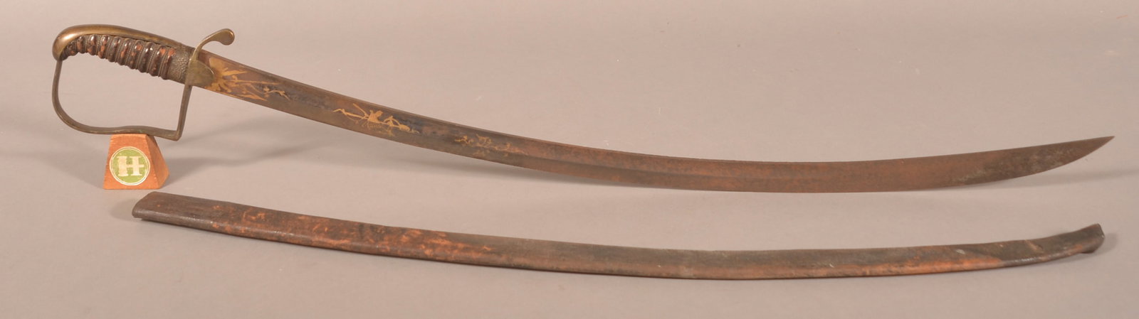 U.S. War of 1812 Brass-Hilted Saber.: Unmarked attributed to Frederick W. Widmann, Philadelphia, PA. Single-edged etched blade with narrow fuller at either side of the spine and acute point. Leather grip intact with grapevine mountings. W