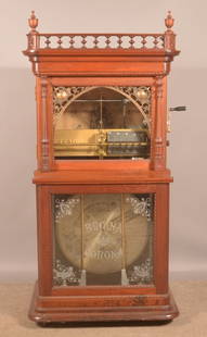 Regina Corona-Style 32-Disc Music Box.: Coin-operated automatic disc changer. Including twelve 20-3/4" discs. The Regina Music Box Co. New Jersey. Built from 1899 to 1905. Serial # 45082. Victorian carved mahogany case. 67" H x 32-1/2" W x