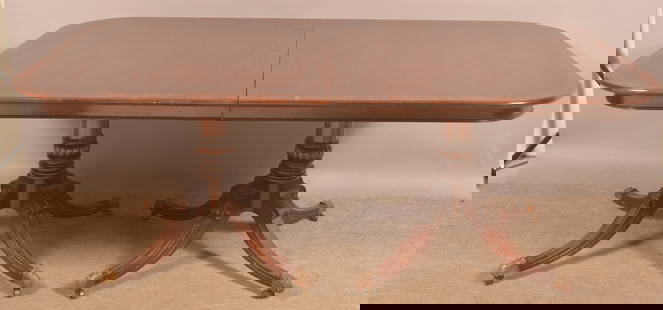 Mahogany Period-Style Extension Dining Table.: Carved double pedestal base with brass capped feet. 29-1/2" H x 47" W x 76" L with three 24" W. boards (one with a skirt).