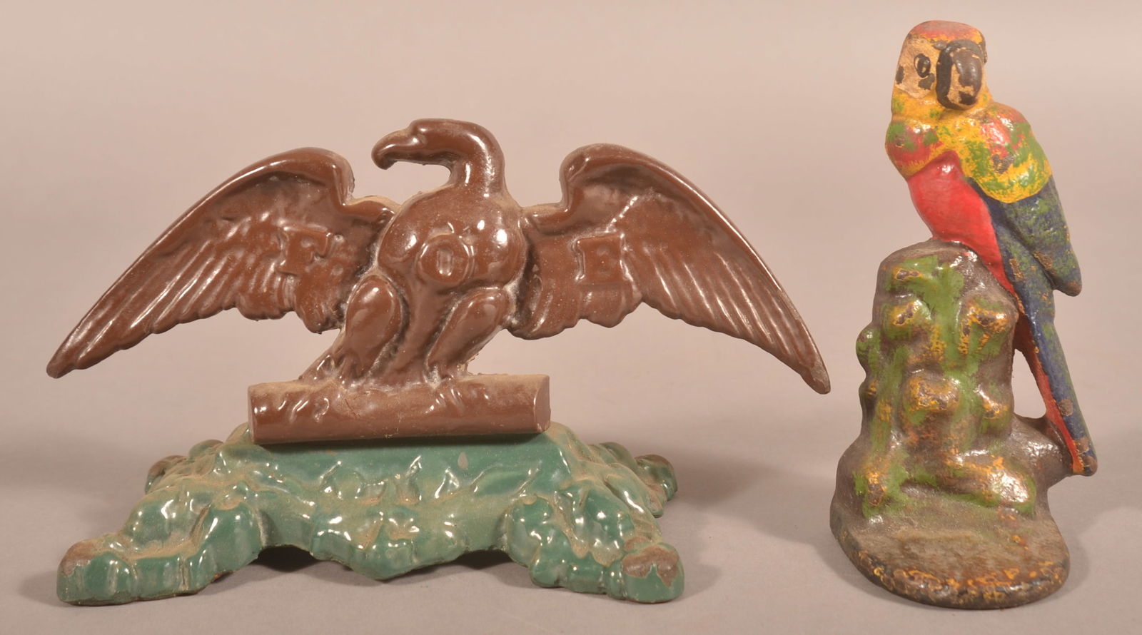 Two Vintage Cast Iron Bird-Form Doorstops.: Enameled F.O.E. eagle and parrot. 5-1/2" H x 9-1/2" W x 4" "D and 6-1/4" H x 3-1/2" W x 3" D