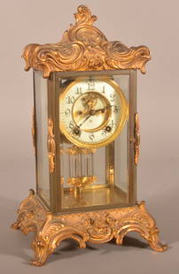 Antique Ansonia Brass Case Carriage Clock.: Ornate case with gilt-decorated bronze ormolu mountings. Enameled dial, chiming brass works and mercury filled pendulum. 15-1/2" H x 8-3/4" W x 7-3/4" D