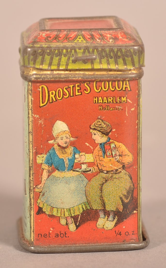 Droste's Sample Cathedral Top Sample Cocoa Tin.: Wonderful graphics of a Dutch Couple drinking cocoa, marked "Free Sample" on reverse. Provenance: Dean Getz Collection. 1-7/8" H x 1-1/8" W x 1-1/8"D
