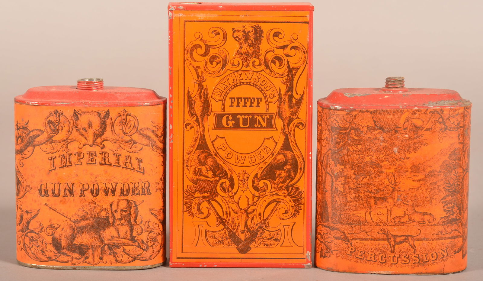 Three Great Orange & Black Early Gunpowder Tins.: Two oval shapes with paper labels. One for Eureka Powder Works, New Durham NH. No name on the other oval tin which has wonderful graphics of buck, doe and hunting dogs. The vertical square corner tin