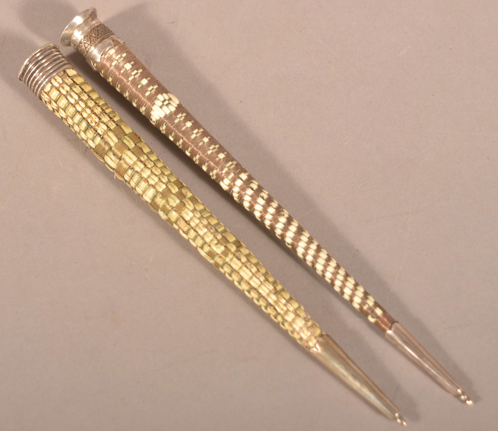 Two Antique Silver-Mounted Knitting Needle Cases.: Both are woven with goose feather rachis, one is woven with copper wire, the other with brass wire. 7" and 7-1/2"l.